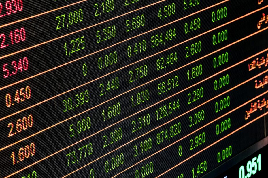 A bustling stock market trading floor with digital tickers and traders.
