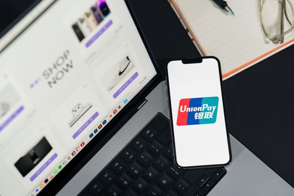 Digital currencies on a smartphone screen, illustrating stablecoins powering everyday retail transactions and AI-driven gig economy