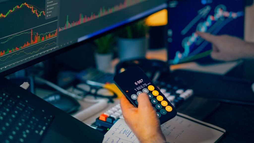 A person working at a desk with multiple monitors displaying cryptocurrency charts and data.