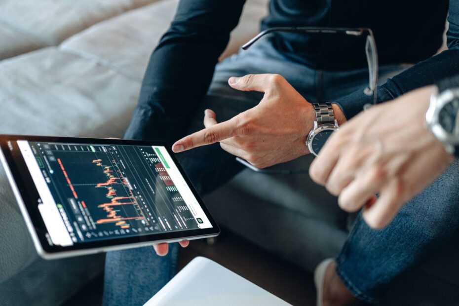 Person looking at multiple screens with crypto charts and news, making a strategic decision.