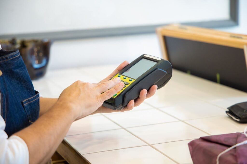 An AI-powered robot hand exchanging stablecoins with a human hand, symbolizing efficient digital payments for microbusinesses.