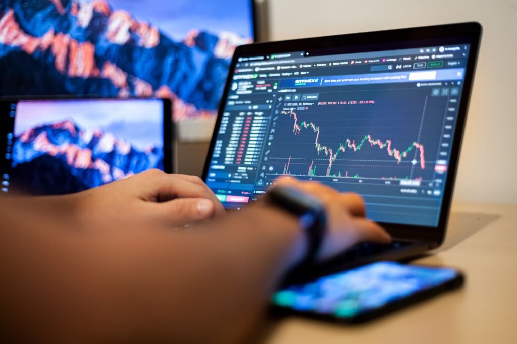 A focused individual working on a laptop displaying cryptocurrency charts, symbolizing crypto productivity.
